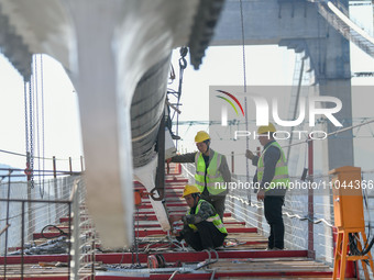 Workers are working at the construction site of Jinzhou Bridge in Xingyi City, Qiandinan Buyi and Miao Autonomous Prefecture, Guizhou Provin...