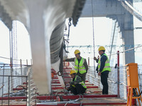 Workers are working at the construction site of Jinzhou Bridge in Xingyi City, Qiandinan Buyi and Miao Autonomous Prefecture, Guizhou Provin...