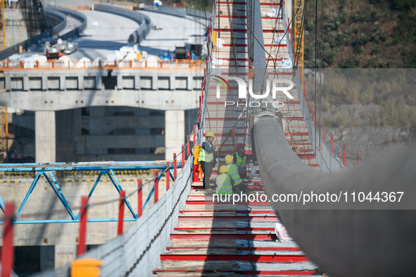 Workers are working at the construction site of Jinzhou Bridge in Xingyi City, Qiandinan Buyi and Miao Autonomous Prefecture, Guizhou Provin...