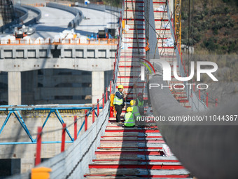 Workers are working at the construction site of Jinzhou Bridge in Xingyi City, Qiandinan Buyi and Miao Autonomous Prefecture, Guizhou Provin...