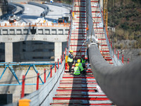 Workers are working at the construction site of Jinzhou Bridge in Xingyi City, Qiandinan Buyi and Miao Autonomous Prefecture, Guizhou Provin...