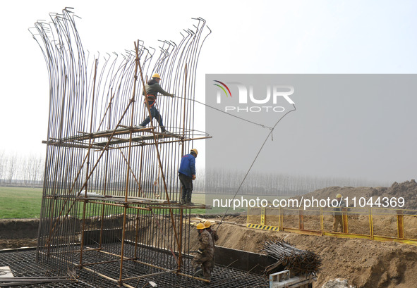 Workers are carrying out railway pier and column construction at the Fanji town section of the Nanjing-Huai'an Intercity Railway under const...