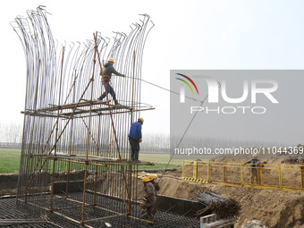 Workers are carrying out railway pier and column construction at the Fanji town section of the Nanjing-Huai'an Intercity Railway under const...