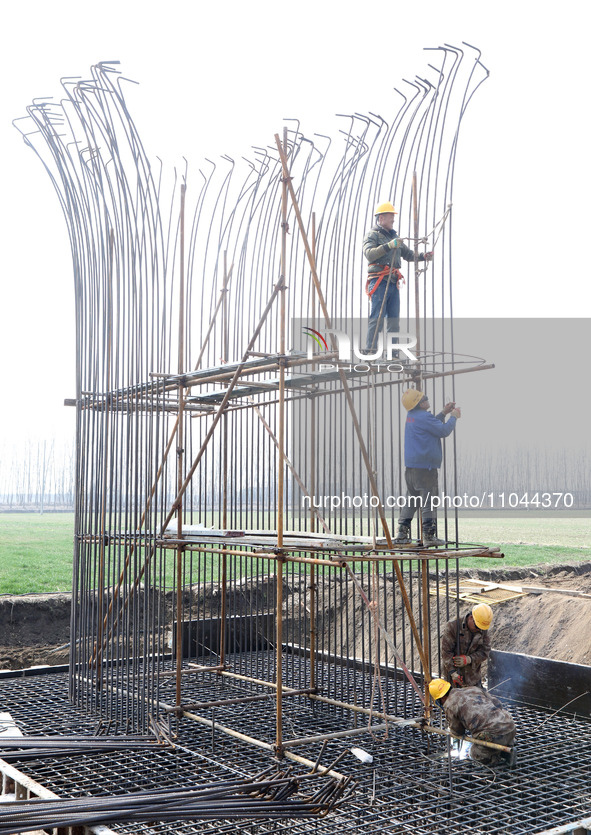 Workers are carrying out railway pier and column construction at the Fanji town section of the Nanjing-Huai'an Intercity Railway under const...