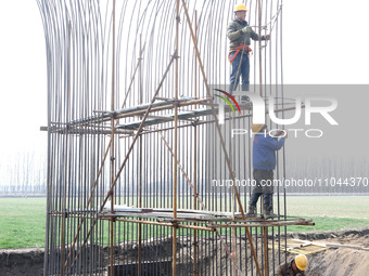 Workers are carrying out railway pier and column construction at the Fanji town section of the Nanjing-Huai'an Intercity Railway under const...