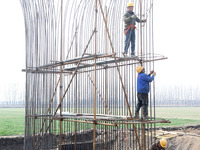 Workers are carrying out railway pier and column construction at the Fanji town section of the Nanjing-Huai'an Intercity Railway under const...