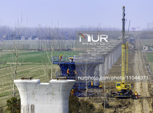 Workers are carrying out railway pier and column construction at the Fanji town section of the Nanjing-Huai'an Intercity Railway under const...