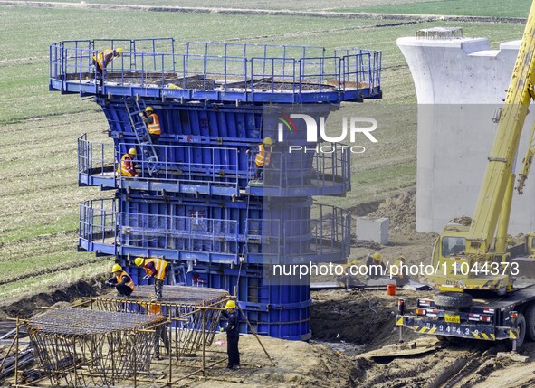 Workers are carrying out railway pier and column construction at the Fanji town section of the Nanjing-Huai'an Intercity Railway under const...