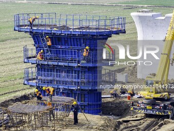 Workers are carrying out railway pier and column construction at the Fanji town section of the Nanjing-Huai'an Intercity Railway under const...