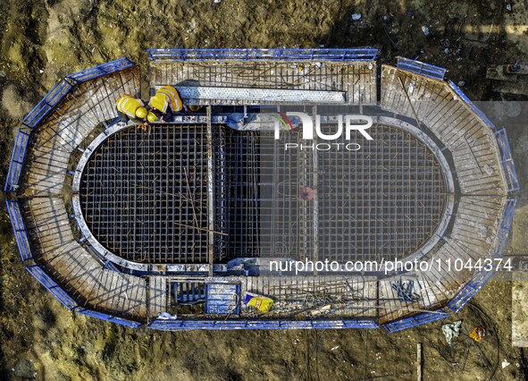 Workers are carrying out railway pier and column construction at the Fanji town section of the Nanjing-Huai'an Intercity Railway under const...