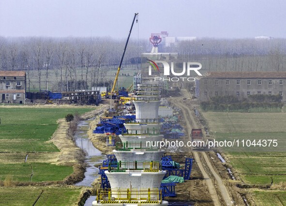 Workers are carrying out railway pier and column construction at the Fanji town section of the Nanjing-Huai'an Intercity Railway under const...