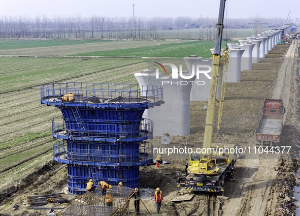 Workers are carrying out railway pier and column construction at the Fanji town section of the Nanjing-Huai'an Intercity Railway under const...