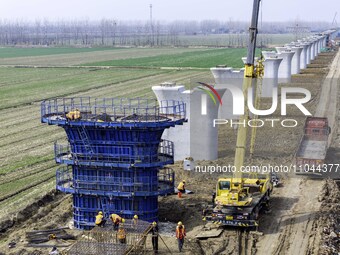 Workers are carrying out railway pier and column construction at the Fanji town section of the Nanjing-Huai'an Intercity Railway under const...