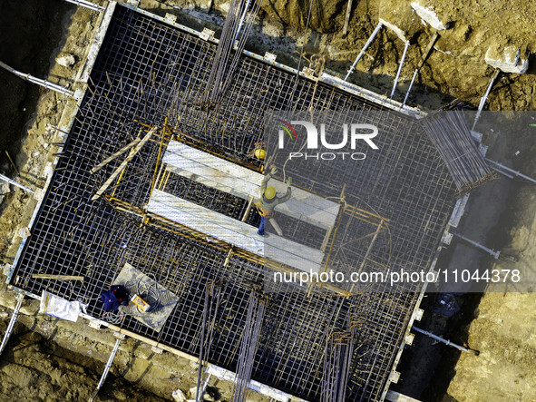 Workers are carrying out railway pier and column construction at the Fanji town section of the Nanjing-Huai'an Intercity Railway under const...