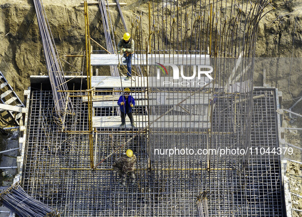 Workers are carrying out railway pier and column construction at the Fanji town section of the Nanjing-Huai'an Intercity Railway under const...