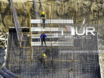 Workers are carrying out railway pier and column construction at the Fanji town section of the Nanjing-Huai'an Intercity Railway under const...