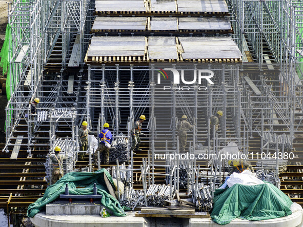 Workers are carrying out railway pier and column construction at the Fanji town section of the Nanjing-Huai'an Intercity Railway under const...