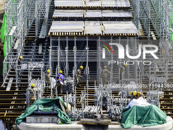 Workers are carrying out railway pier and column construction at the Fanji town section of the Nanjing-Huai'an Intercity Railway under const...