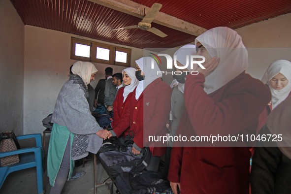 Students are greeting their teacher on the first day of school in Srinagar, Kashmir, on March 4, 2024. Schools across Kashmir are reopening...