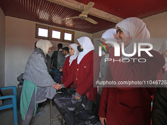 Students are greeting their teacher on the first day of school in Srinagar, Kashmir, on March 4, 2024. Schools across Kashmir are reopening...