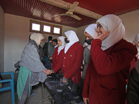 Students are greeting their teacher on the first day of school in Srinagar, Kashmir, on March 4, 2024. Schools across Kashmir are reopening...