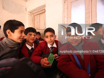 School boys are pictured on the first day of school in Srinagar, Kashmir, on March 4, 2024. Schools across Kashmir are reopening after a thr...