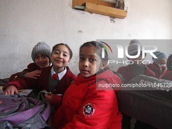 School girls are pictured on the first day of school in Srinagar, India, on March 4, 2024. Schools across Kashmir are reopening after a thre...