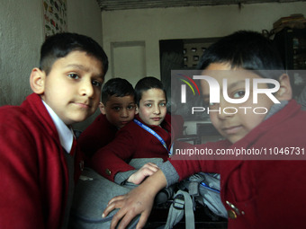 School boys are sitting inside the classroom on the first day in Srinagar, Kashmir, on March 4, 2024. Schools across Kashmir are reopening a...