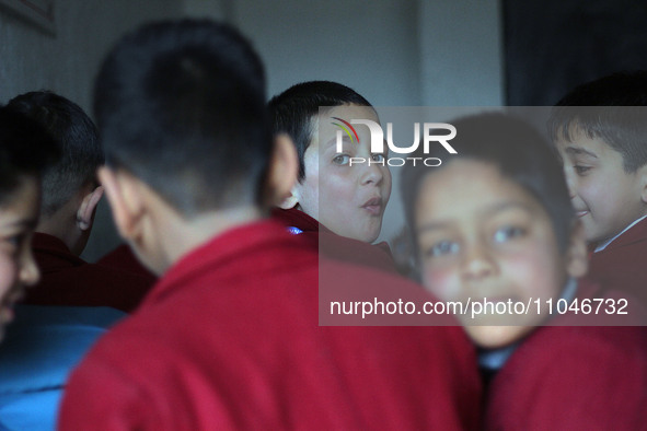 A school boy is pictured on the first day of school in Srinagar, Kashmir, on March 4, 2024. Schools across Kashmir are reopening after a thr...