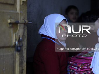 A schoolboy is sitting in the classroom on the first day of school in Srinagar, Kashmir, on March 4, 2024. Schools across Kashmir are reopen...