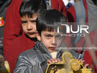 A school boy is pictured on the first day of school in Srinagar, Kashmir, on March 4, 2024. Schools across Kashmir are reopening after a thr...