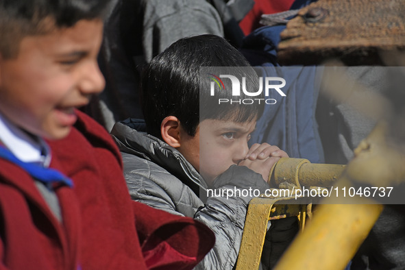 A school boy is pictured on the first day of school in Srinagar, Kashmir, on March 4, 2024. Schools across Kashmir are reopening after a thr...