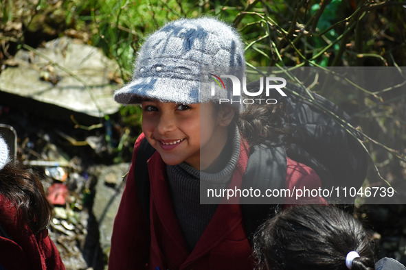 A school girl is pictured on the first day of school in Srinagar, India, on March 4, 2024. Schools across Kashmir are reopening after a thre...