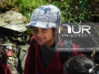 A school girl is pictured on the first day of school in Srinagar, India, on March 4, 2024. Schools across Kashmir are reopening after a thre...