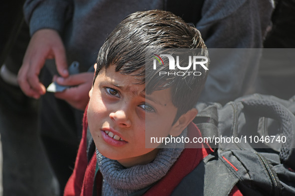 A school boy is pictured on the first day of school in Srinagar, Kashmir, on March 4, 2024. Schools across Kashmir are reopening after a thr...