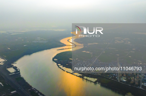 The Huaihongxin River is winding through Shuanggou town in Suqian, China, at sunset on March 3, 2024. 