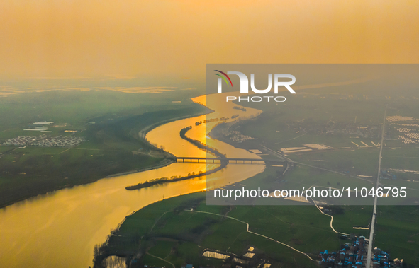 The Huaihongxin River is winding through Shuanggou town in Suqian, China, at sunset on March 3, 2024. 