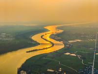 The Huaihongxin River is winding through Shuanggou town in Suqian, China, at sunset on March 3, 2024. (