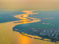 The Huaihongxin River is winding through Shuanggou town in Suqian, China, at sunset on March 3, 2024. (