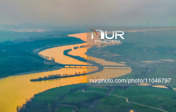 The Huaihongxin River is winding through Shuanggou town in Suqian, China, at sunset on March 3, 2024. 