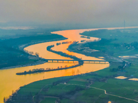 The Huaihongxin River is winding through Shuanggou town in Suqian, China, at sunset on March 3, 2024. (