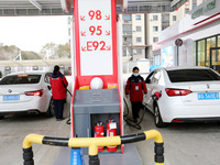 A worker is filling up a car at a gas station in Lianyungang, China, on March 4, 2024. (