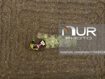 A villager is using a micro-cultivator to sort the land in Shengli Village, Zhongtang Town, Qianjiang District, in Chongqing, China, on Marc...