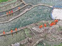 Female volunteer members are walking on the road for forest protection in Jinpin, China, on March 5, 2024. (