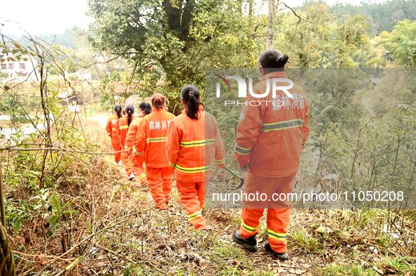 Female volunteer members are patrolling the forest in the mountains in Jinpin County, Guizhou, China, on March 5, 2024. 