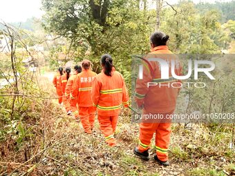 Female volunteer members are patrolling the forest in the mountains in Jinpin County, Guizhou, China, on March 5, 2024. (