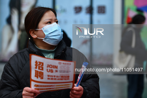 Job seekers are looking for suitable positions at a job fair for women in Fuyang, China, on March 6, 2024. 