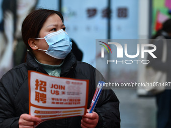 Job seekers are looking for suitable positions at a job fair for women in Fuyang, China, on March 6, 2024. (