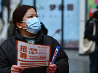 Job seekers are looking for suitable positions at a job fair for women in Fuyang, China, on March 6, 2024. (