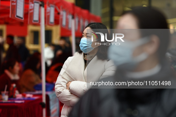 Job seekers are looking for suitable positions at a job fair for women in Fuyang, China, on March 6, 2024. 